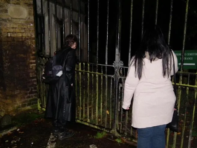 Gareth J. Medway and Shar Ray take a brave peek through the gates of Highgate Cemetery Photo: Dave Milner; (c) BPOS