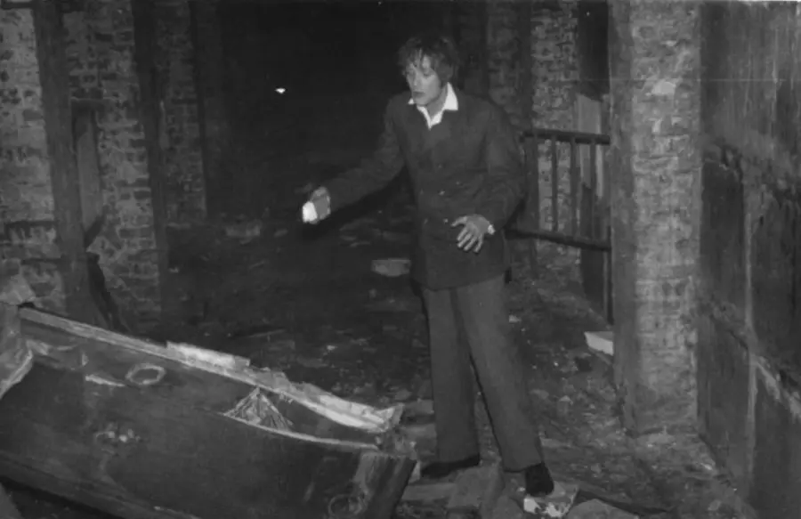 David Farrant shining a torch onto a vandalised coffin - Terraced Catacombs - Highgate Cemetery - The Highgate Vampire